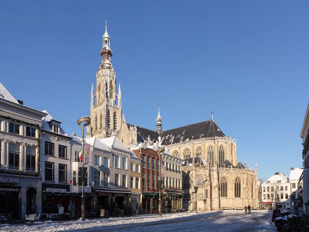 Breda: een laatgotische kerk met een hoge, slanke toren boven de Grote Markt